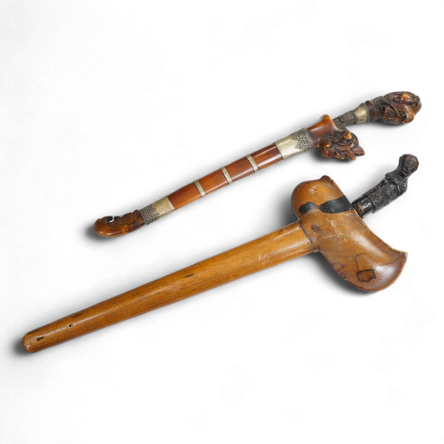 A Javanese dagger kris with straight pamor blade, wooden hilt carved as raksha, in its wooden sheath, together with a decorative dagger bade-bade, with etched blade